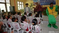 Dua orang master diver Yitno dan Sarif yang memakai kostum hiu dan kura-kura menghibur para siswa.