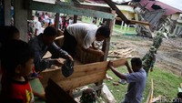 Aparat TNI tampak membantu pembangunan musala darurat tersebut.