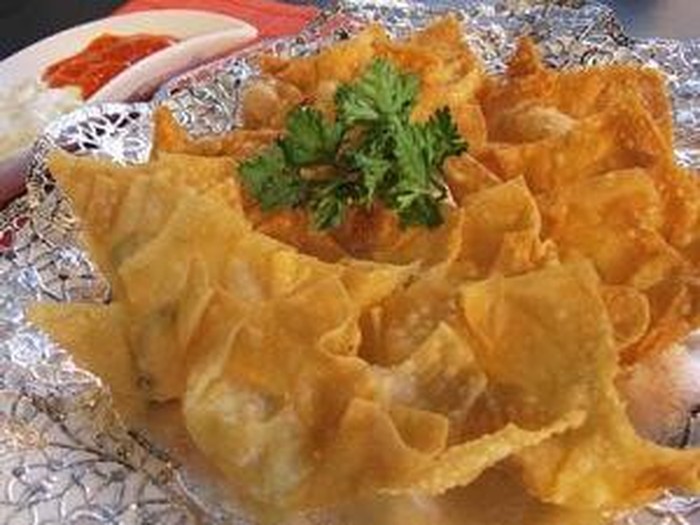 Deep fried dumplings and dipping sauce on plate
