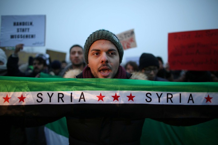 Demonstrators calling for peace in Syria protest in front of the parliament building Reichstag in Berlin, Germany December 17, 2016.     REUTERS/Christian Mang