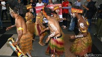 Mereka melakukan aksi tarian Papua.