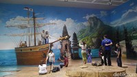 Dari sekian banyak ruangan, ada sebuah tempat cukup besar. Di sana terdapat lukisan 3 dimensi pura di Bali serta perahu yang memenuhi dinding setinggi 2 lantai (Kurnia/detikTravel)