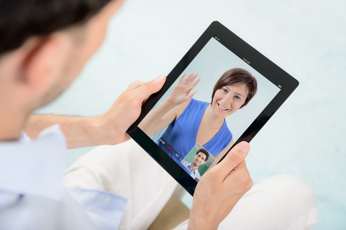 A young couple talking to each other via online video chat.
