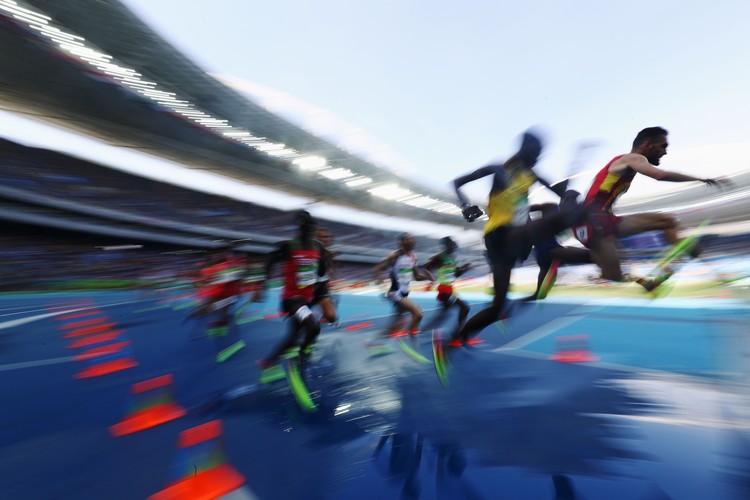 RIO DE JANEIRO, BRAZIL - AUGUST 15:  Athletes clear the water jump as they compete in the Mens 3000 metres Steeplechase heats on Day 10 of the Rio 2016 Olympic Games at the Olympic Stadium on August 15, 2016 in Rio de Janeiro, Brazil.  (Photo by Alexander Hassenstein/Getty Images)