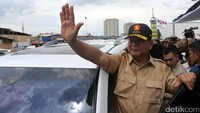 Prabowo melambaikan tangan ke arah warga Kampung Akuarium.