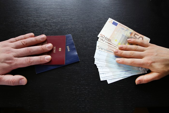 buying illegal foreign passport hands exchanging money and documents buyer seller