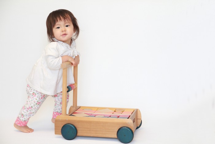 Japanese baby girl pushing a cart (1 year old)