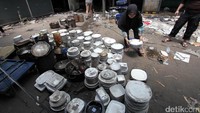 Para pedagang menyelamatkan barang-barang dagangan yang tersisa.