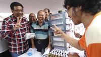 Djarot dan warga menunjukkan salam dua jari usai mengikuti pengobatan gratis. Pool/Timses Ahok-Djarot.