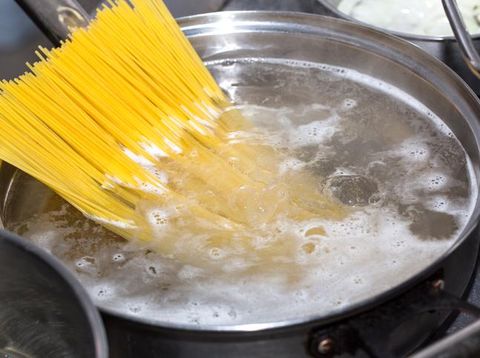 Spaghetti in pan with cheese sauce