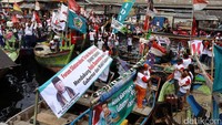 Dalam parade ini, kapal nelayan dihiasi dengan bendera merah putih dan poster bergambar Anies-Sandi.