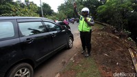 Polisi mengatur arus lalu lintas.