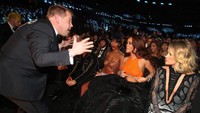 Duh, apa yang dibicarakan James Corden hingga membuat Rihanna membetulkan busananya. Christopher Polk/Getty Images for NARAS