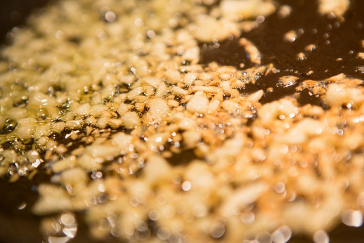 sauteing garlic in a pan with olive oil