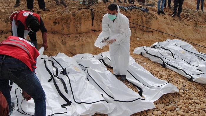 A rescue worker labels bags containing dead bodies of migrants who were washed up on a beach near the city of Zawiya, Libya February 20, 2017. Picture taken February 20, 2017. Libyan Red Crescent/Handout via REUTERS ATTENTION EDITORS - THIS PICTURE WAS PROVIDED BY A THIRD PARTY. FOR EDITORIAL USE ONLY. NO RESALES. NO ARCHIVE.