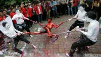 Sejumlah mahasiswa yang tergabung dalam Gerakan Mahasiswa Nasional Indonesia (GMNI) menggelar unjuk rasa lewat aksi teatrikal di depan kantor Freeport, Kuningan, Jakarta, Jumat (24/2/2017).