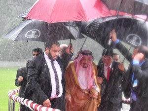 Saat Jokowi Memayungi dan Menggandeng Raja Salman