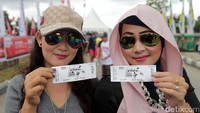 Penonton menunjukan tiket masuknya.