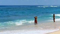 Foto: Dua turis asing berbikini yang tengah menikmati segarnya air di Pantai Melasti (Ardan/detikTravel)