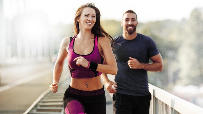 Fitness couple workout - fit man and woman train in gym