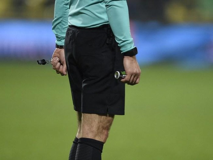 Referee holds a spray and a whistle during the French L1 football match between Metz (FCM) and Nantes (FCN) on February 18, 2017 at the Saint Symphorien stadium in Longeville-Les-Metz, eastern France. / AFP PHOTO / Jean Christophe VERHAEGEN