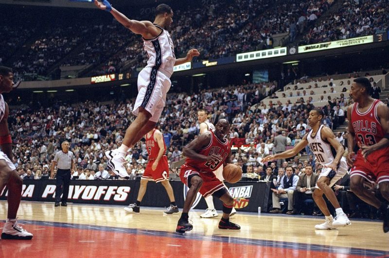 Chicago Bulls - Michael Jordan 29 Apr 1998: Michael Jordan #23 of the Chicago Bulls in action against Jason Williams #55 of the New Jersey Nets during the NBA Playoffs round 3 game at the Continental Airlines Arena in East Rutherford, New Jersey. The Bulls defeated the Nets 116-101.