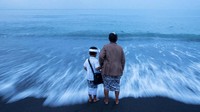 Seorang ibu dan anaknya mengikuti upacara Melasti. REUTERS/Agung Parameswara.