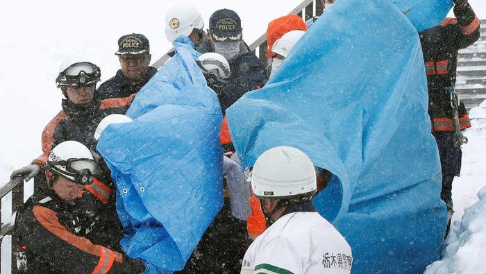 Rescue workers carry victims after an avalanche hit a group of high school students and teachers climbing near a ski resort in Nasu town, north of Tokyo, Japan, in this photo taken by Kyodo March 27, 2017. Mandatory credit Kyodo/via REUTERS    ATTENTION EDITORS - THIS IMAGE WAS PROVIDED BY A THIRD PARTY. EDITORIAL USE ONLY. MANDATORY CREDIT. JAPAN OUT. NO COMMERCIAL OR EDITORIAL SALES IN JAPAN. THIS PICTURE WAS PROCESSED BY REUTERS TO ENHANCE QUALITY. AN UNPROCESSED VERSION HAS BEEN PROVIDED SEPARATELY.     TPX IMAGES OF THE DAY