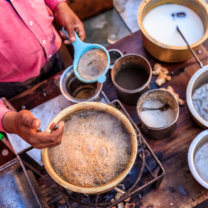 Indian street seller selling tea- masala chai in Jaipur. Masala chai is a beverage from the Indian subcontinent made by brewing tea with a mixture of aromatic Indian spices and herbs. Jaipur is the capital city of Rajasthan. Jaipur is known as the Pink City, because of the color of the stone exclusively used for the construction of all the structures.