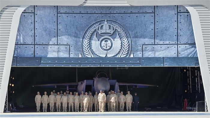 A handout picture released by the Saudi Royal Palace shows Saudi Air Force officers standing at attention in front of an advanced F-15SA fighter jet during a ceremony. (Photos by AFP)