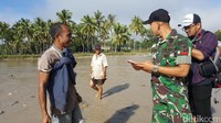 Anggota TNI dari Satgas Pamtas Batalyon Infantri Raider 641/Beruang memeriksa dokumen pelintas batas. Mereka sangat ramah kepada warga (Fitraya/detikTravel)