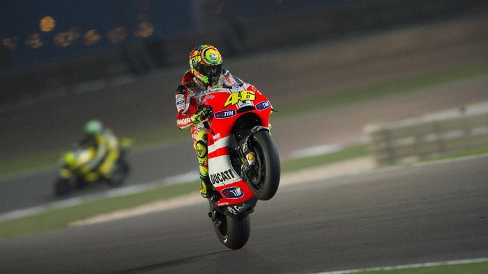 DOHA, QATAR - MARCH 20:  Valentino Rossi of Italy and Ducati Marlboro Team lifts the front wheel at the end of MotoGP race of  MotoGP of Qatar at Losail Circuit on March 20, 2011 in Doha, Qatar.  (Photo by Mirco Lazzari gp/Getty Images)