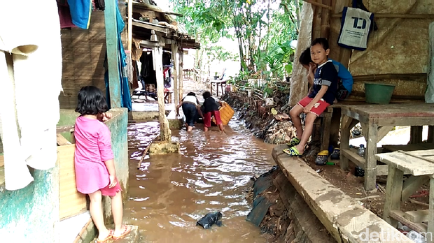 Anak-anak Asyik Bermain Perahu di Tengah Banjir Tebet