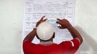 Seorang warga mengabadikan hasil penghitungan suara di TPS 17.