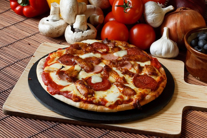 Barbecue or BBQ meat feast pizza with a topping of pepperoni, sausage, salami and chicken wings