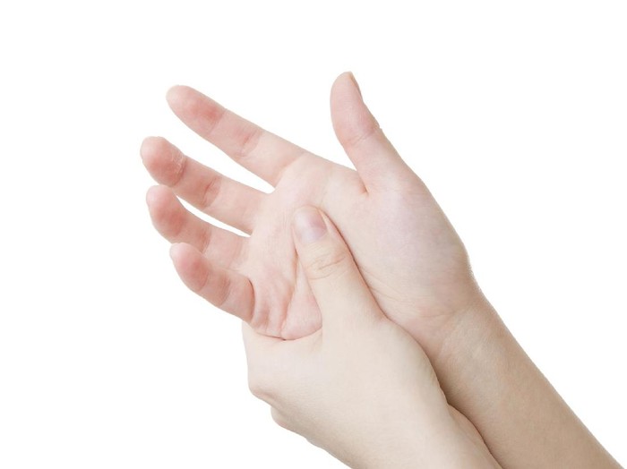 pijat tangan Massage the palm. Care of female hands isolated on white background.