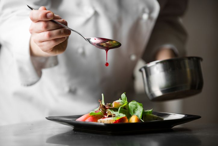 Waiter working at a restaurant and taking an order to a couple of young people
