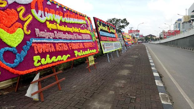 Seratusan karangan bunga juga meluber ke jalanan.