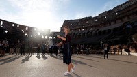Sharapova mengayun raket di balik bayang-bayang Colosseum (Foto: REUTERS/Stefano Rellandini)