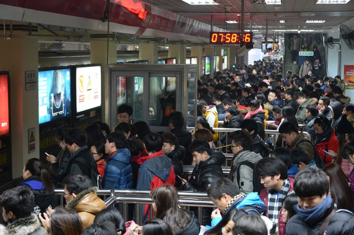 BEIJING, CHINA - DECEMBER 29:  (CHINA OUT) People wait for a subway at Sihui East Station during the first weekday after the subway adpoted new fare policy on December 29, 2014 in Beijing, China. Beijings subway has adopted new price policy on Sunday. The starting fare for subway rised to 3 RMB (about 0.48 USD) and only cover the first 6 km ride compared with the previous falt-fare 2 RMB (about 0.32 USD) for unlimited transfers. The subway fares will be charged in accordance to the distance you ride which may double the previous prices on average.  (Photo by VCG/VCG via Getty Images)