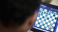 Digelar secara online, bidak catur dimainkan lewat laptop. Scott Olson/Getty Images.