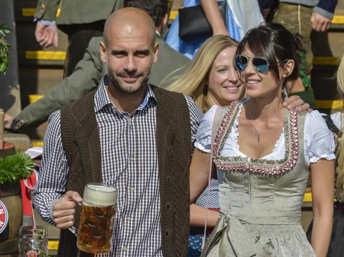Pep Guardiola Cristina Serra Bayern Munichs Spanish head coach Pep Guardiola and his wife Cristina Serra wear traditional Bavarian dresses as they attend German first division Bundesliga football club Bayern Munichs annual visit at the Oktoberfest beer festival in Munich, southern Germany, on September 30, 2015. AFP PHOTO / GUENTER SCHIFFMANN / AFP PHOTO / GUENTER SCHIFFMANN