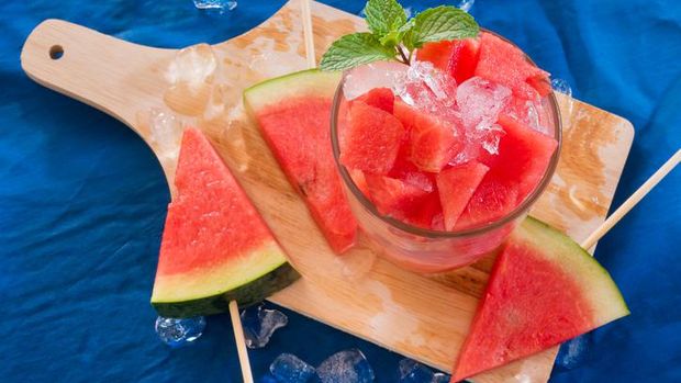 Fresh mojito with watermelon on a wooden table