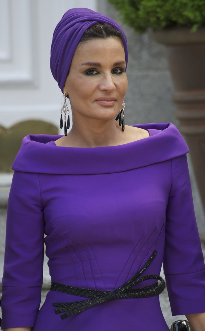 PARIS - JULY 14:  Sheikha Moza Bint Nasser al-Misnad, wife of the Qatari Emir, and French first lady Carla Bruni-Sarkozy attend the Bastille Day ceremony on July 14, 2008 in Paris, France.  Syrian President Bashar al-Assad attended the Champs-Elysees military parade, alongside other European, North African and Middle Eastern leaders, which has caused controversy due to Syria's ties to organisations classified as terrorist by the several countries. (Photo by Francois Durand/Getty Images)
