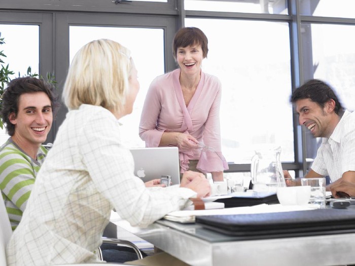 business-034935 Businesswomen and men laughing sitting at conference table