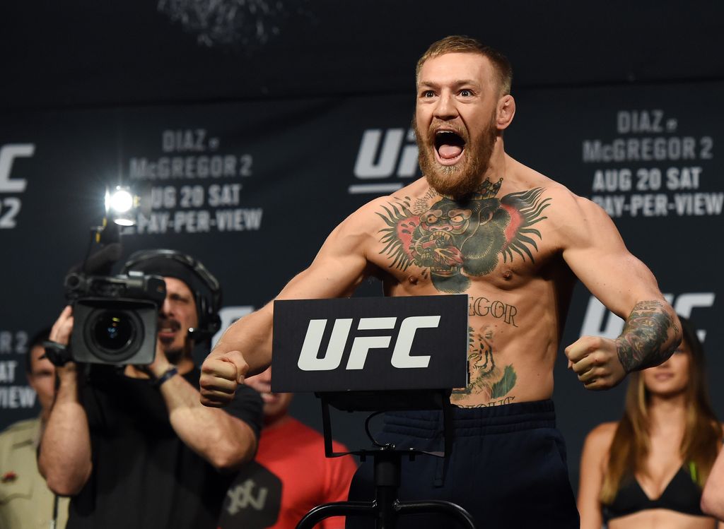 LAS VEGAS, NV - AUGUST 19:  UFC featherweight champion Conor McGregor poses on the scale during his weigh-in for UFC 202 at MGM Grand Conference Center on August 19, 2016 in Las Vegas, Nevada. McGregor will meet Nate Diaz in a welterweight rematch on August 20, 2016, at T-Mobile Arena in Las Vegas.  (Photo by Ethan Miller/Getty Images)