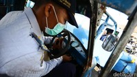 Petugas Dishub mencoba menghidupkan bemo yang terjaring razia.