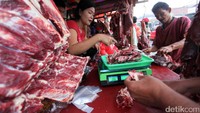 Pedagang melayani pembeli.