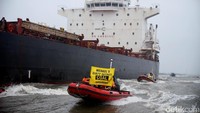 Greenpeace menghadang laju kapal besar menggunakan perahu karet.
