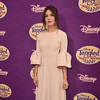 Pilihan gaun bell sleeve merah muda memberikan kesan feminin pada gayanya Mandy Moore kali ini. Foto: Getty Images